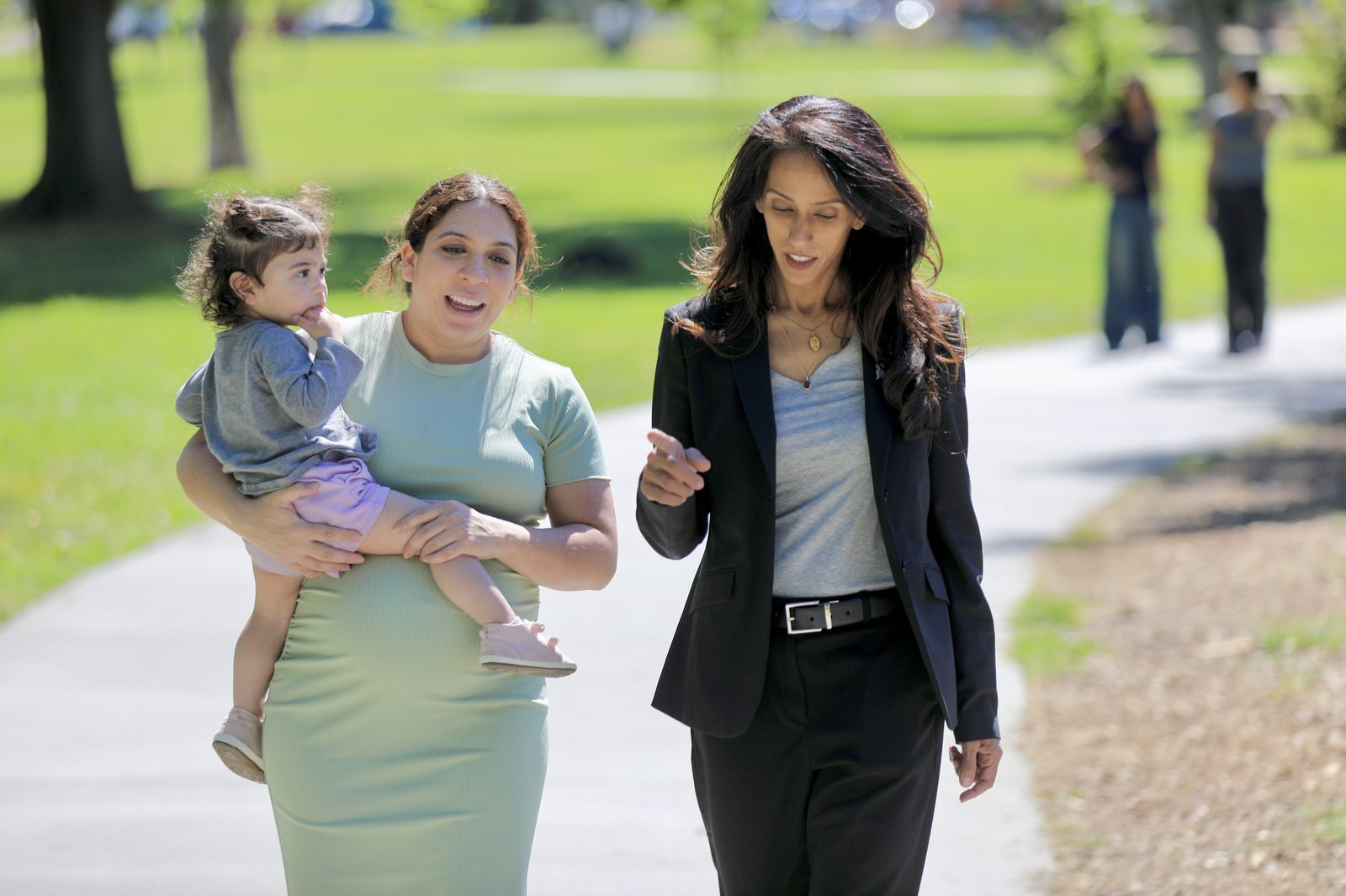 Rakhi listening to a constituent and her child in the East Bay